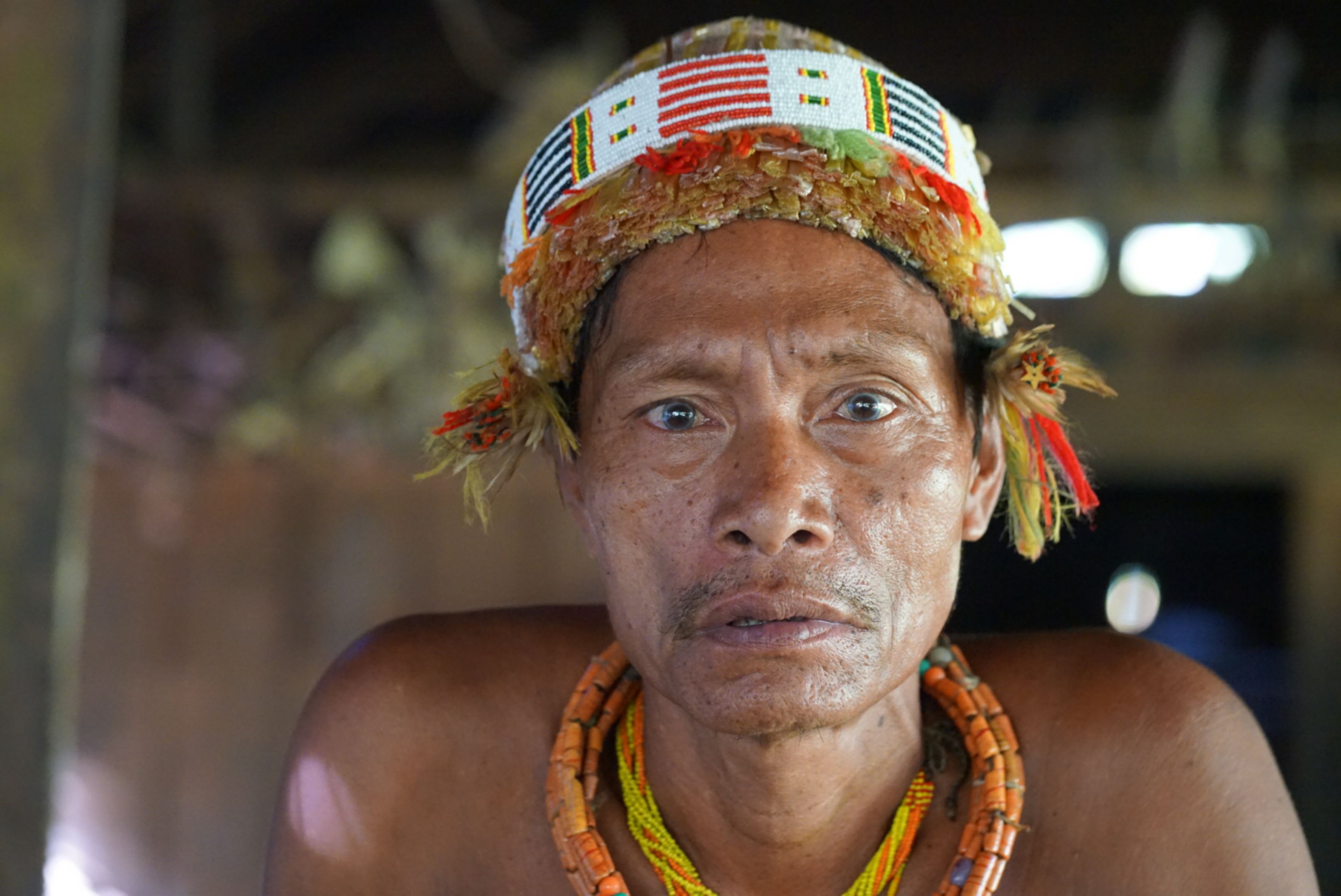 Close-up portrait of an Indigenous man in traditional attire
