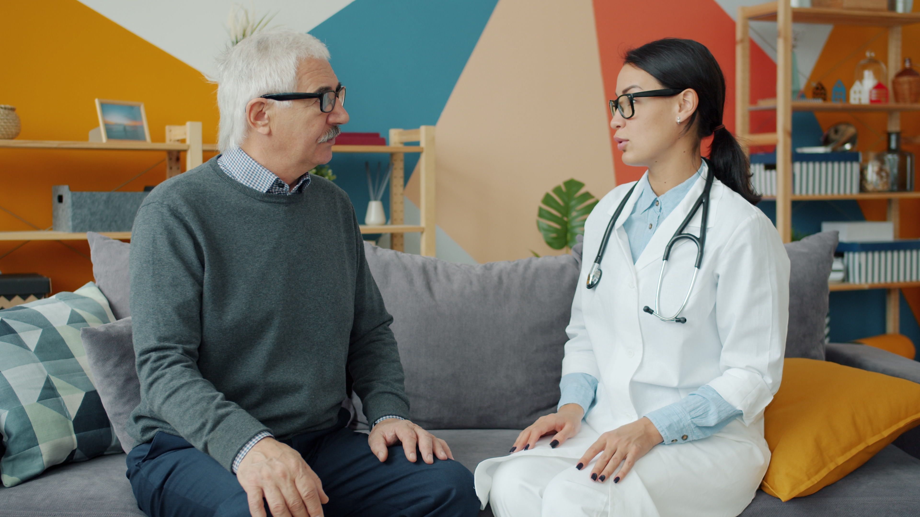 Older man discussing his health and screening options with a doctor in an office