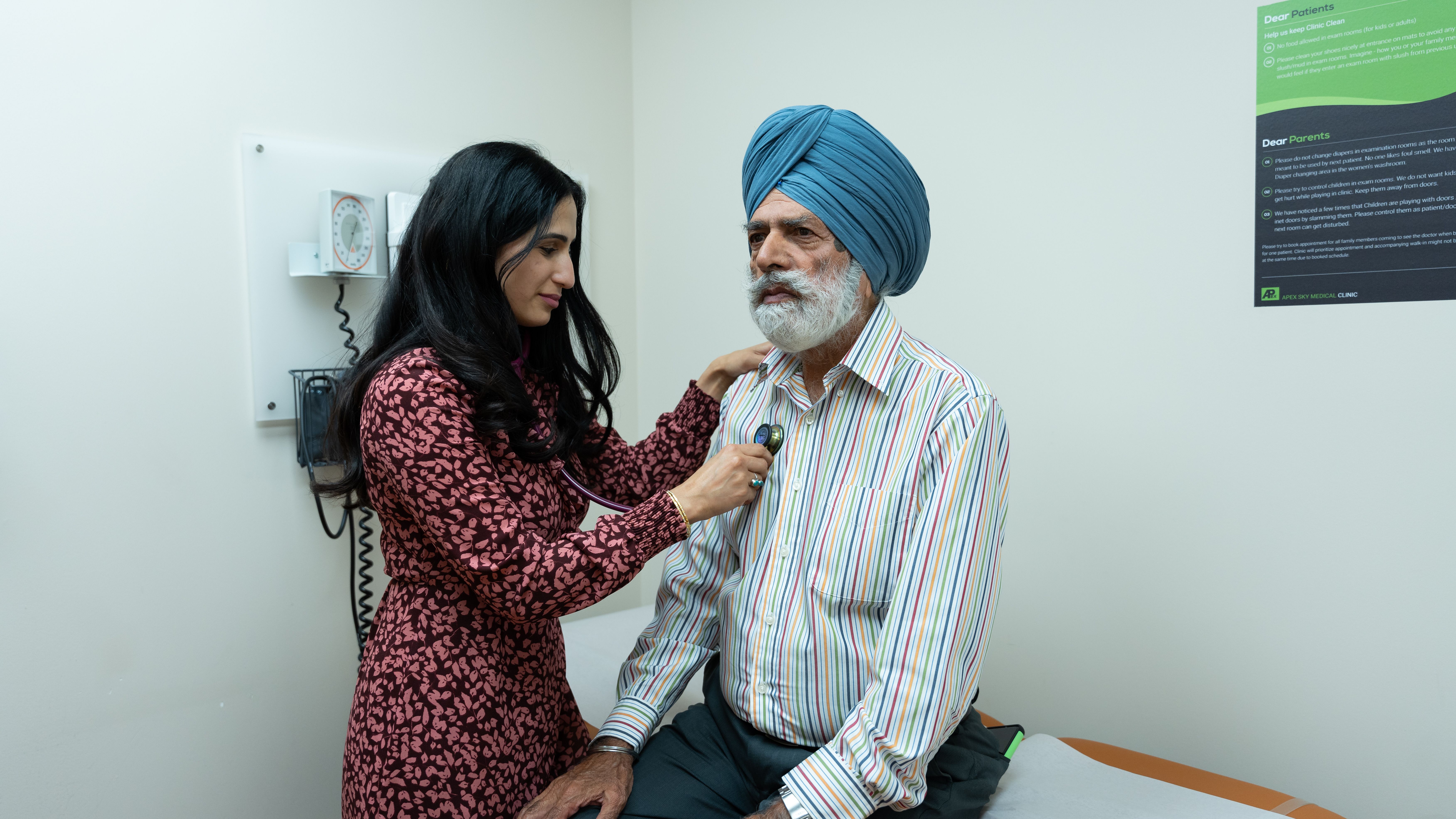 Doctor using a stethoscope to examine a senior man during a routine medical checkup