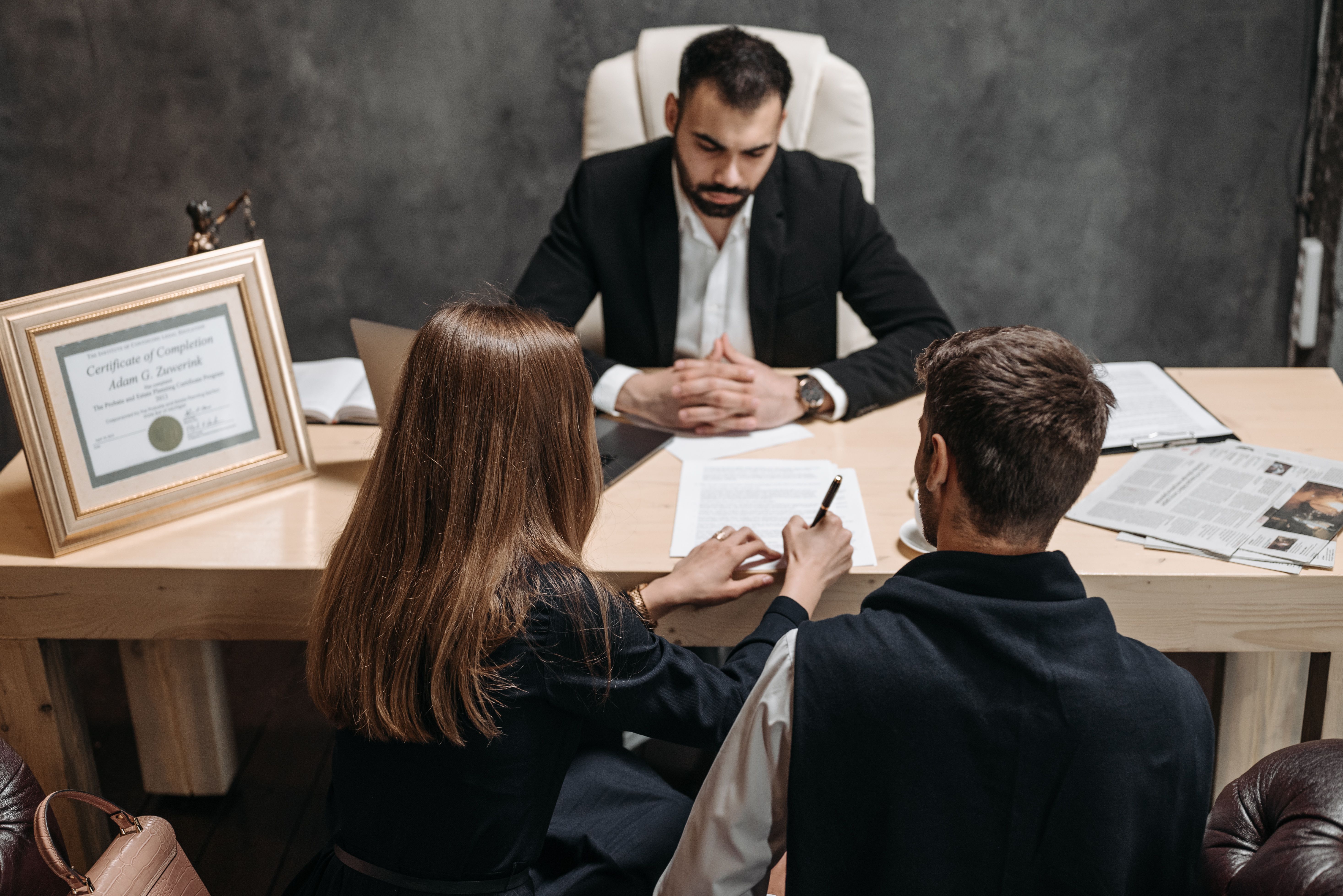 Lawyer discussing legal documents with clients during a case consultation